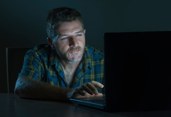 young aroused and excited sex addict man watching porn mobile online in laptop computer light night...
