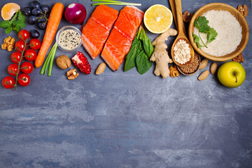 Healthy food clean eating selection: salmon fish, fruits, vegetables, cereals. View from above, top studio shot