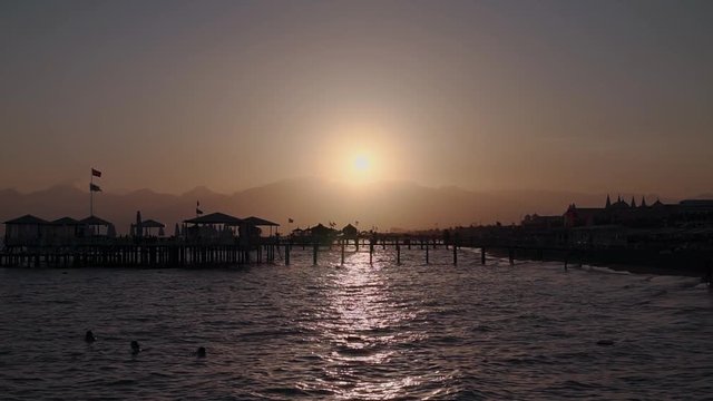 Charming sunset at the beach amazing colors light beam shining through the cloudscape travel yellow calm gold over summer twilight tourist night ocean vacation