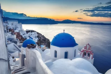 Tuinposter Beautiful view of Santorini island in Greece at sunrise with dramatic sky. © Funny Studio