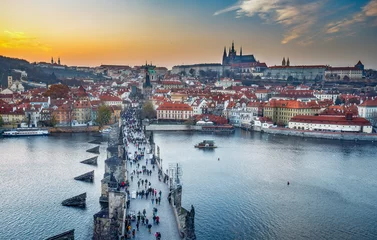 Fotobehang Scenic aerial view on Charles bridge and Prague castle in Prague, Czech Republic, at sunset. Travel background. © Funny Studio