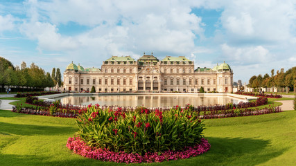 Belvedere palace panorama with a pond and flowers in front of.