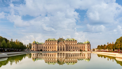 Fototapeta na wymiar Gorgeous Belvedere palace reflecting in a pond. Sunny day in Vienna, Austria.