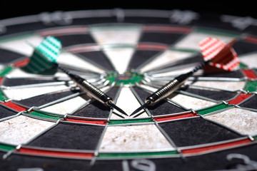 Obraz premium two darts on dartboard