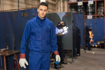 Male engineer with protective vest inside a factory