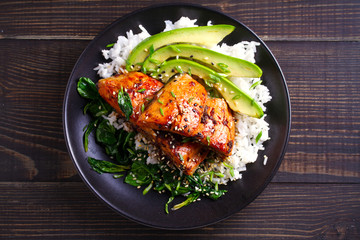 Salmon in honey-soy glaze with rice, spinach and avocado. overhead, horizontal