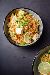Vegetarian fried rice with tofu, peas and vegetables. Asian cuisine, healthy lunch