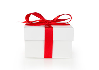 White One gift box with red ribbon bow, isolated on white background