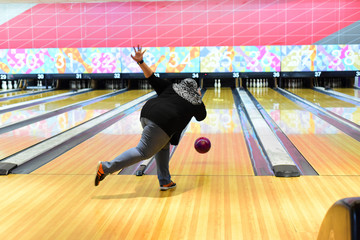 Bowler throw the ball at the bowling lane