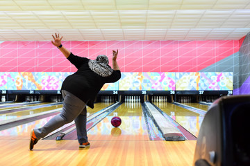 Bowler throw the ball at the bowling lane