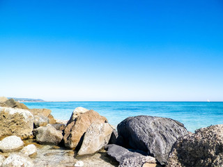 Fototapeta na wymiar Stones on beach in Vada, Italy.
