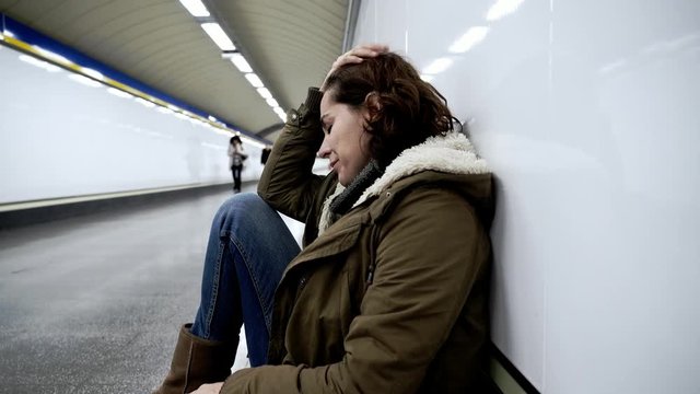 Hopeless and exhausted woman suffering depression and anxiety in subway tunnel in Work-life balance issues Negative body image Financial troubles and Stressful life events Mental health and loos of lo