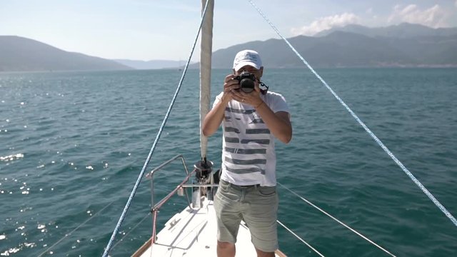 Landscape travel photographer tourist taking photo from sailing boat