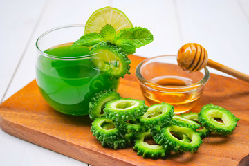 Juice of bitter gourd with raw and sliced bitter gourd.Healthy Herbal Drink
