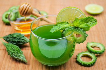 Juice of bitter gourd with raw and sliced bitter gourd.Healthy Herbal Drink