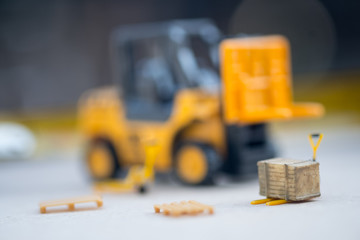 Miniature yellow toy forklift and miniature pallet truck