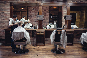Brown Interior Barbershop with people. Men's hairdresser