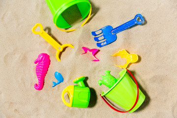 childhood and summer concept - close up of sand toys kit on beach