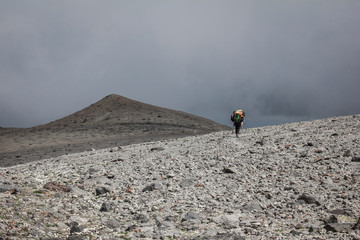 lonely porter on the descent from the mountains in the Caucasus