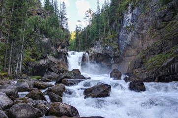 Waterfall on the river Kadrin. Expedition to the unspoilt nature of Altai. Undiscovered Siberia