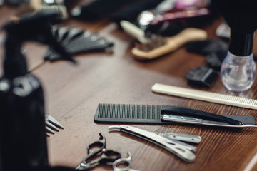 barbershop tools on wooden table. Accessories for shaving and haircuts