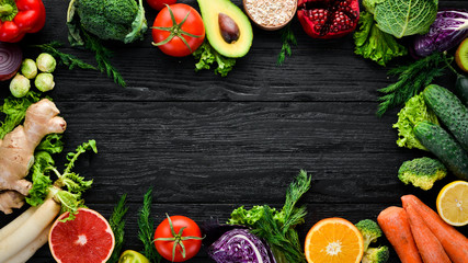 Fresh vegetables and fruits. Organic food on a black wooden background. Top view. Free copy space.