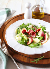 French cuisine. Duck breast salad with cheese and herbs