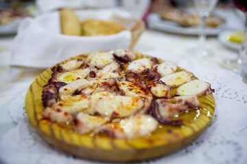 Octopus Galician on wooden plate.