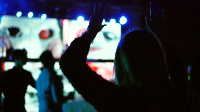 Shot back woman dance at nightclub music and disco lights in the background of the party young attractive fashionable trip travel slow motion