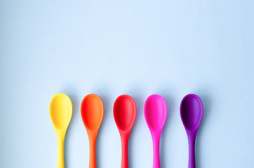 Fletley from multi-colored spoons on a blue background.