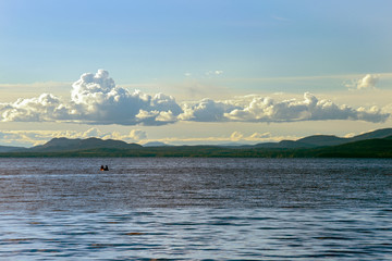 Fishermen in small boat in Stuart Lake at Paaren's Beach Provincial Park, British Columbia, Canada