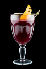 Raspberry mulled wine with orange peel. On dark background. Warming drink.