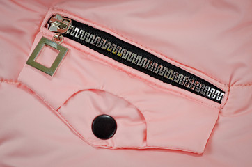 Zipper on the pocket of the pink jacket for children