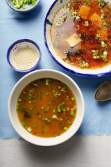 Japanese miso soup with tofu, wakame seaweed, spring onions and pepper flakes