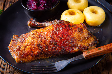 classic and crispy roasted duck with cabbage and dumplings