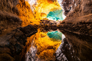 Water optical illusion reflection in Cueva de los Verdes, an amazing lava tube and tourist attraction on Lanzarote island, Spain. - obrazy, fototapety, plakaty