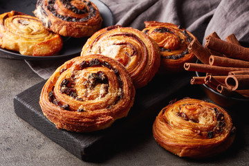 Sweet buns on black board isolated on stone table
