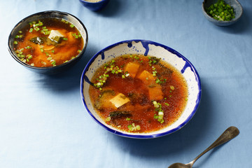 Japanese miso soup with tofu, wakame seaweed, spring onions and pepper flakes