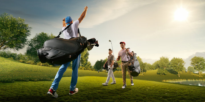 Three male golf players on professional golf course. Smiling golfers walking with golf clubs and golf bags
