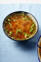 Japanese miso soup with tofu, wakame seaweed, spring onions and pepper flakes