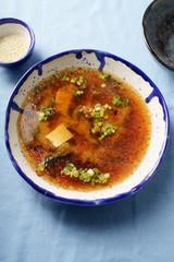 Japanese miso soup with tofu, wakame seaweed, spring onions and pepper flakes