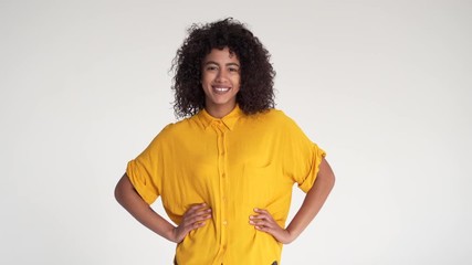 Happy african american woman with arms akimbo