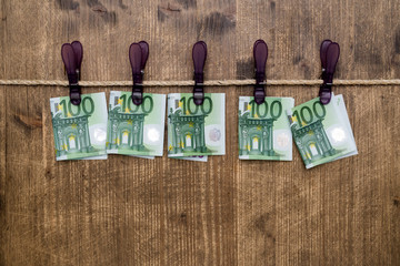 One hundred euro banknotes on clothesline