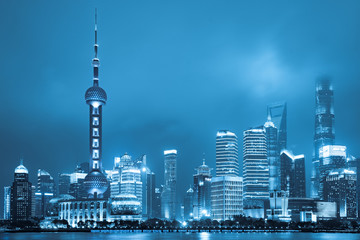 Fototapeta na wymiar Shanghai landmark view business district at night view in blue tone.