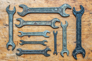 Old vintage wrenches on wooden background. Top view