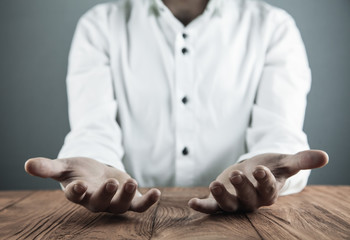 Businessman showing empty hands in his desk.