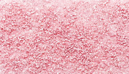 Pastel pink background made with pink sugar. Close-up. Powder pink