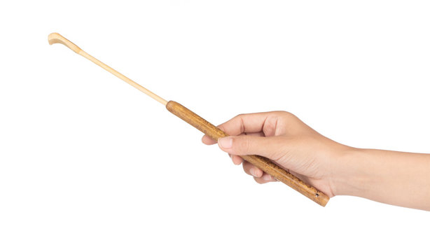 hand holding wood to scratch back isolated on a white background.