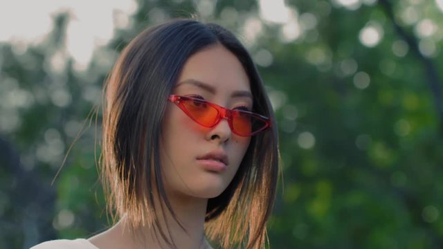 Fashion asian model portrait with creative stylish make-up outdoors