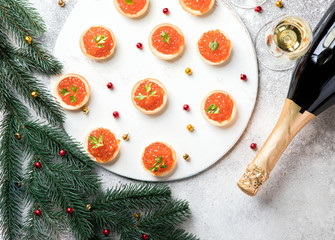 Christmas and New Year holidays composition. Red Salmon Caviar in Tartlets. Festive Appetizer and...